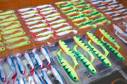 Soft plastic silicone fishing baits in boxes on store