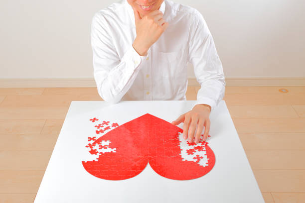 Japanese man is making a red heart puzzle