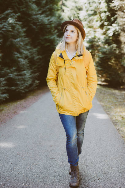 istock Carefree woman standing in forest 654306182