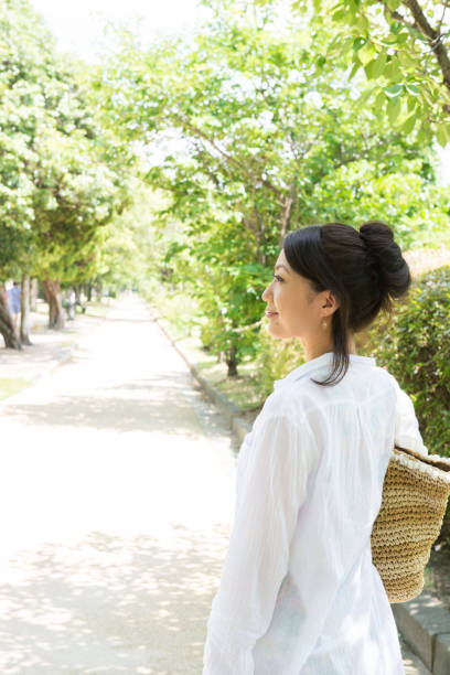 istock Japanese women walk down the tree-lined street 654318314