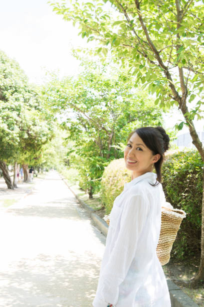 istock Japanese women walk down the tree-lined street 654318326