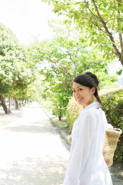 istock Japanese women walk down the tree-lined street 654318336