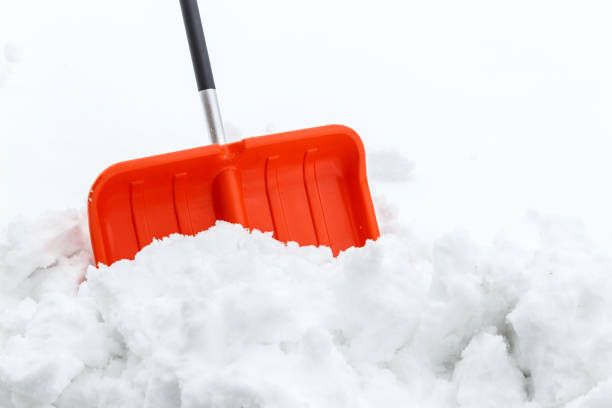 istock Winter shoveling. Removing snow after blizzard. 654323578