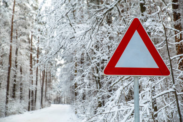 istock Snowy winter road. Attention sign. 654324006