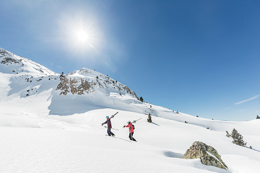 Man and woman backcountry skiers going up the Pyrenees mountains Catalonia Spain