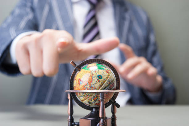 Miniature globe and Japanese businessmen's hands