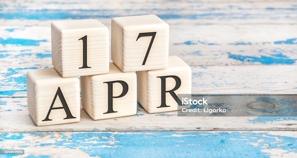 April 17th. Wooden cubes with date of 17 April  on old blue wooden background. Abstract Stock Photo