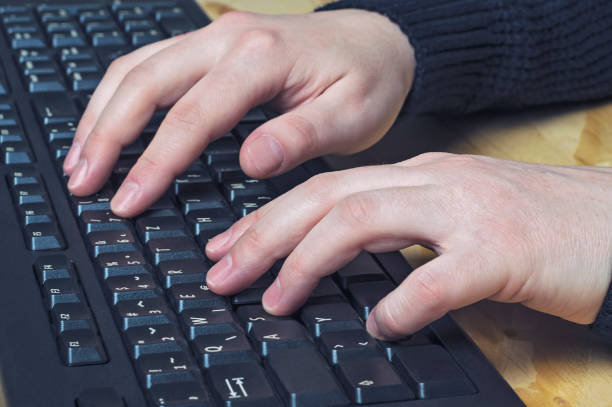 istock Close up of typing female hands on keyboard. 654344262