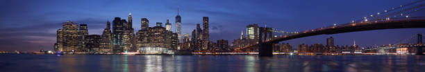 New York city skyline with Brooklyn bridge panorama at dusk New York city skyline with Brooklyn bridge panorama at dusk, natural colors liberty tower stock pictures, royalty-free photos & images