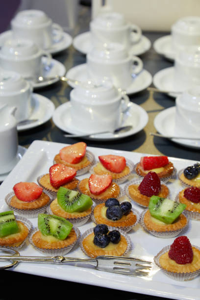 istock Pastries with fruit and coffee cups ready for hotel breakfast 654349894
