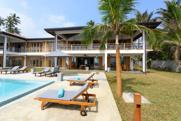 istock Sun loungers on poolside with luxury apartment 654350076
