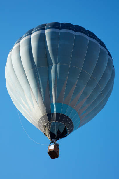 istock Hot air balloon, blue tones aerostat on clear sky 654350630