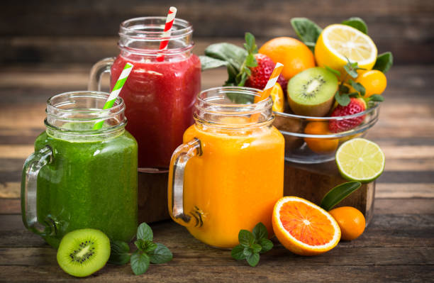 healthy fruit and vegetable smoothies - orange smoothie imagens e fotografias de stock
