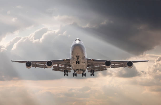 istock jumbo jet airplane landing in storm 654360364
