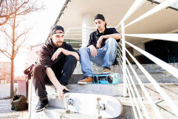 istock two young skateboarder relax on the outskirts stairs 654376406