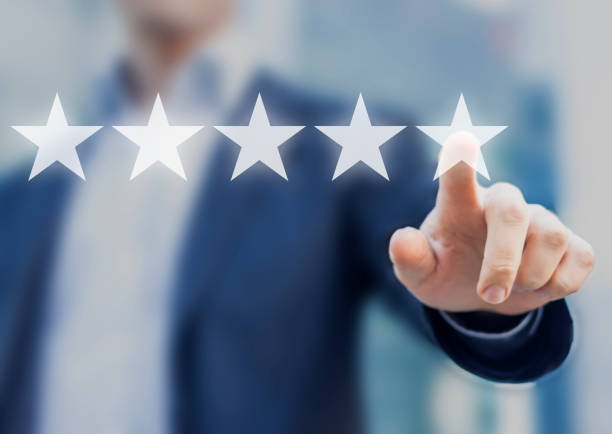 istock Five stars (5) rating with a businessman touching screen 654381814