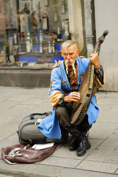 Ukrainian gusla player Krakow, Poland - JUNE 13: Unknown Ukrainian gusla player on June 13, 2007 in Krakow. cirque de soleil stock pictures, royalty-free photos & images