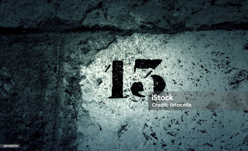 Number thirteen wall Number thirteen in stone wall, sign and symbol Luck Stock Photo