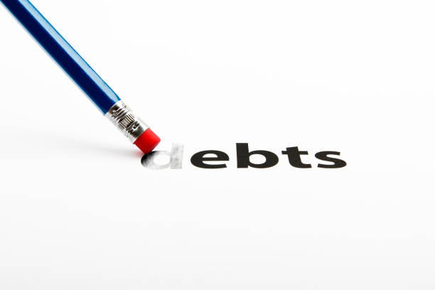 istock Blue pencil-eraser is rubbing the word DEBTS 654385928