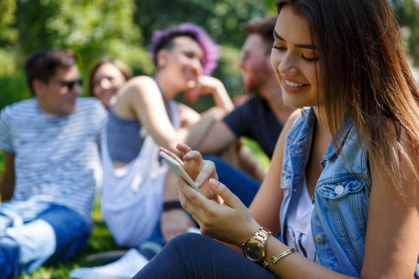 istock Young beautiful woman using smart phone outdoor 654392158