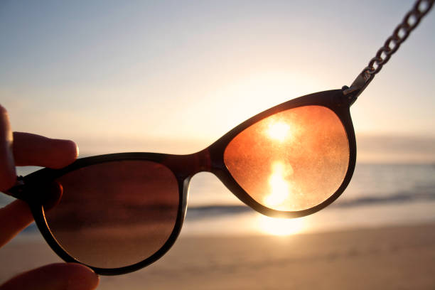 istock Looking through Sunglasses at the Sunset on a Beach 654392354