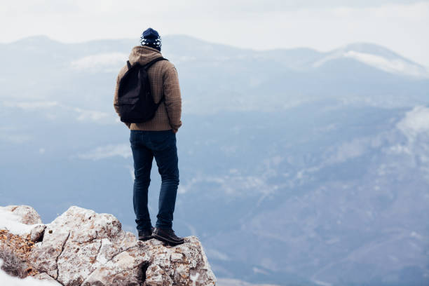 istock Traveler with backpack looks on a mountain peak 654394842