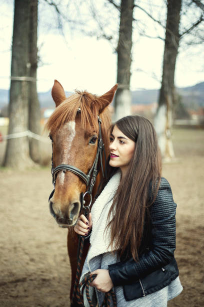 istock Pretty young women and horse 654395364