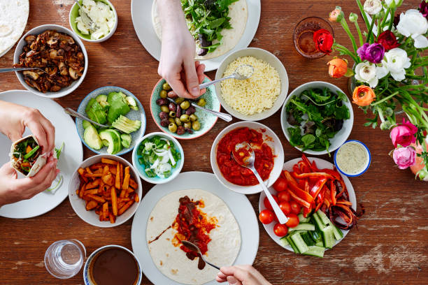 istock friends making healthy organic fresh wraps together dinner party 654397866