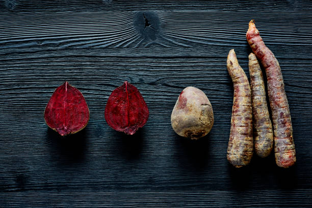 beetroots and carrots on dark wood  special foods on dark wood