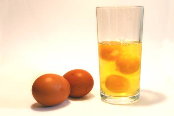 Body Building nutrition, raw eggs in a glass stock photo