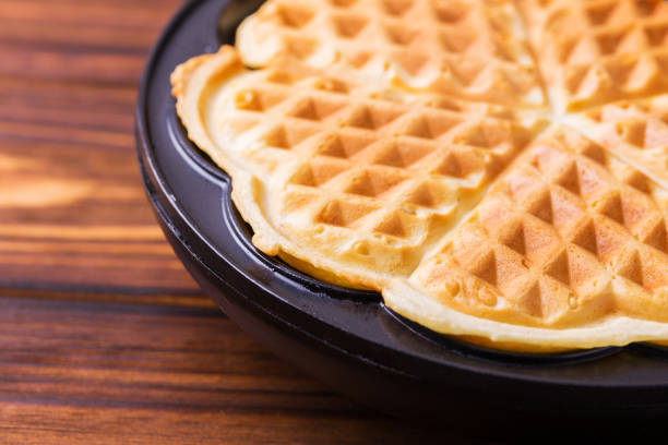 istock Homemade heart shaped waffles in iron waffle pan 654404724