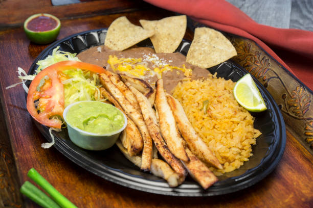 istock Spanish Mexican Cuisine Dinner Plate Chicken Refried Beans Salsa Chips 654407778