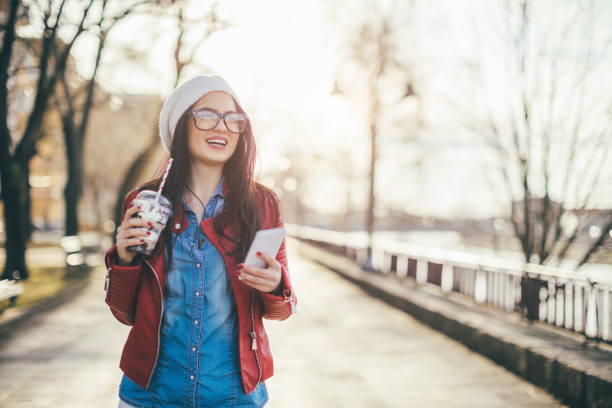 istock Casual woman looking at mobile phone 654410466