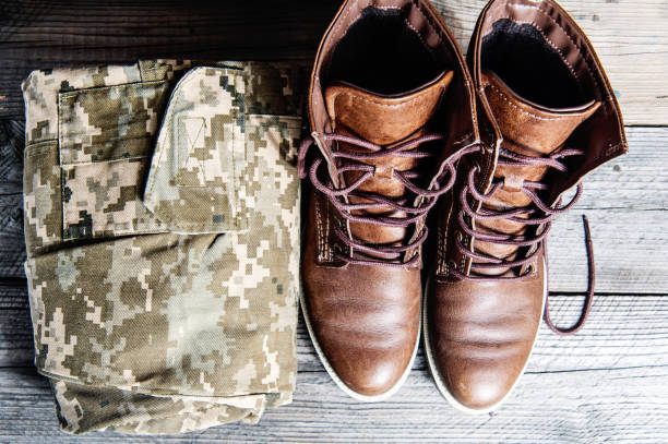 istock military uniform on Wooden floor 654411978