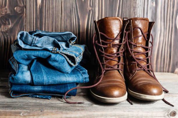 istock Shoes and stack of jeans 654411984