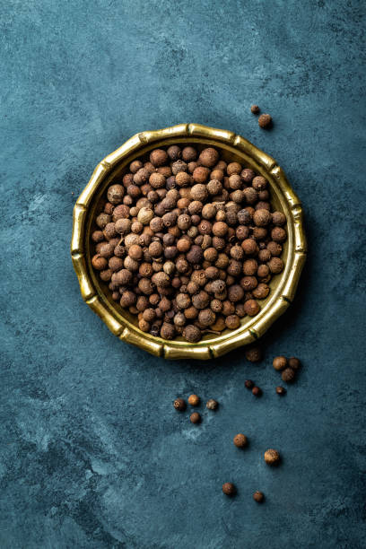 istock Allspice pepper, peppercorns on dark culinary background, top view, copy space 654414726
