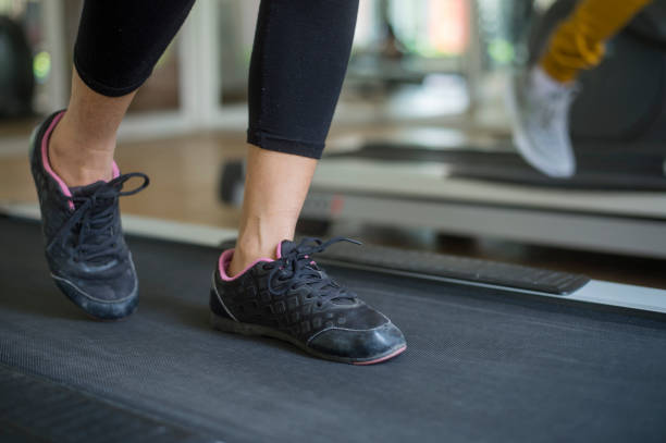 istock woman running on treadmill in gym 654424458