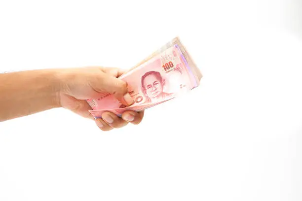 Asian'man Hand holding thailnad banknote on white background isolated