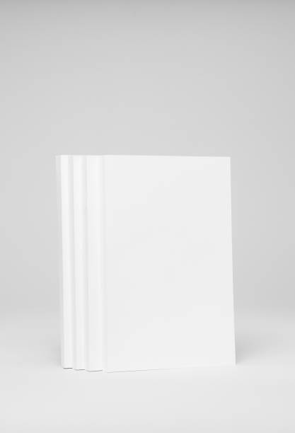 istock Real paperback white books on a gray background 654443876