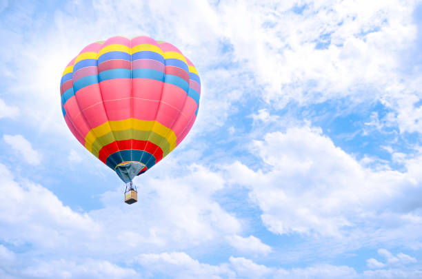istock Colorful balloon over bright sky with clouds. 654448330