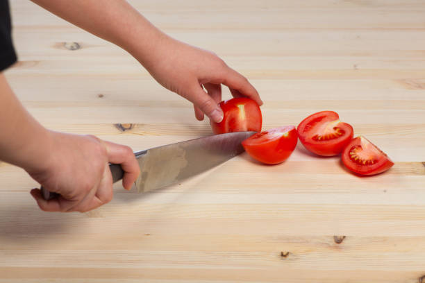 istock Cutting tomatoes for dishes on the table. Vegetables during the cooking process dishes. Vegetables for healthy eating and dieting 654491058