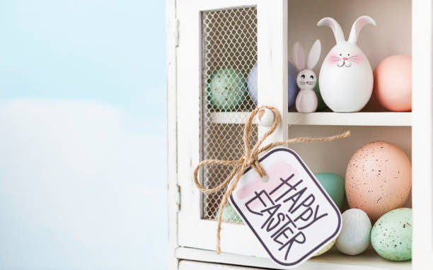 Easter collection of eggs and rabbits in white cabinet