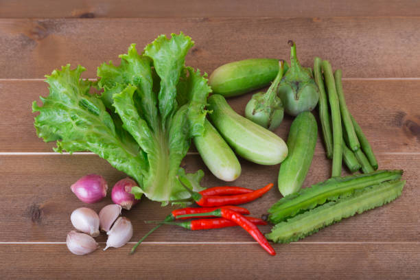istock group of vegetable cucumbers,thai eggplants,long beens,Winged beans,lettuce,chilli,shallots,garlic 654506408