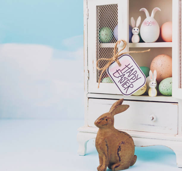 istock Easter collection of eggs and rabbits in white cabinet 654510452