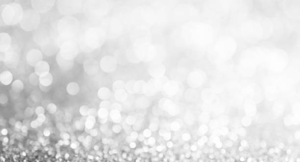 istock silver and white bokeh lights defocused. abstract background, wide fan page panorama format. 654512760