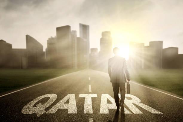 istock Businessman with suitcase and Qatar word 654525030