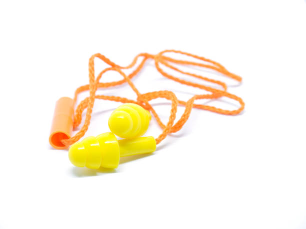 istock Close-up orange ear plugs on white background. 654525512