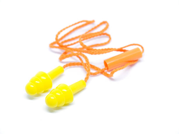 istock Close-up orange ear plugs on white background. 654525524