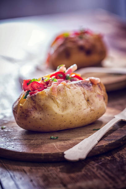 istock Baked Potato with Sour Cream, Bacon and Chili 654534782