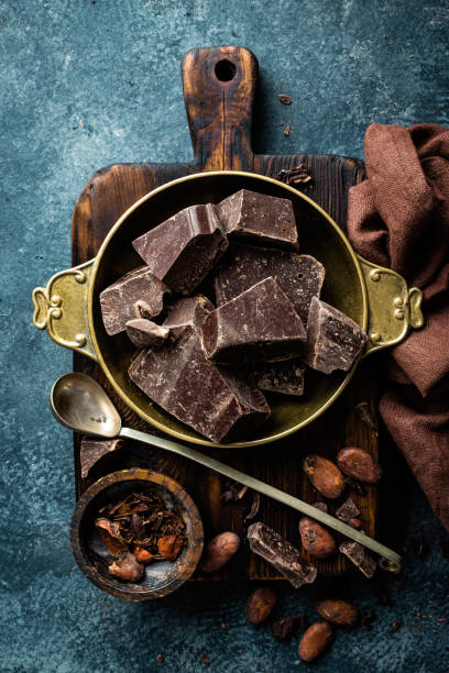 istock Dark chocolate pieces crushed and cocoa beans, culinary background, top view 654544016